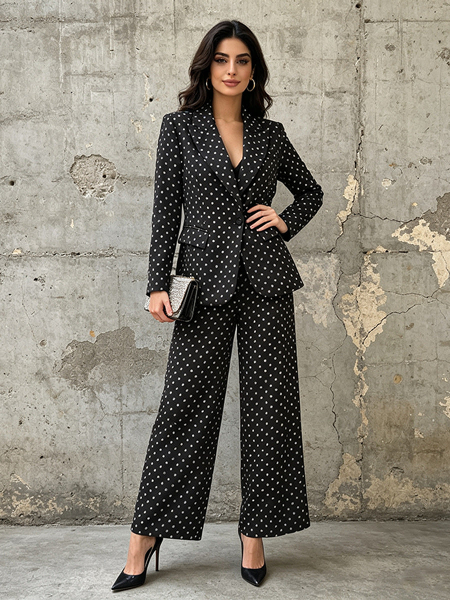 Polka dot blazer and wide leg trouser suit set in black – on model front view showing tailored fit and wide leg silhouette
