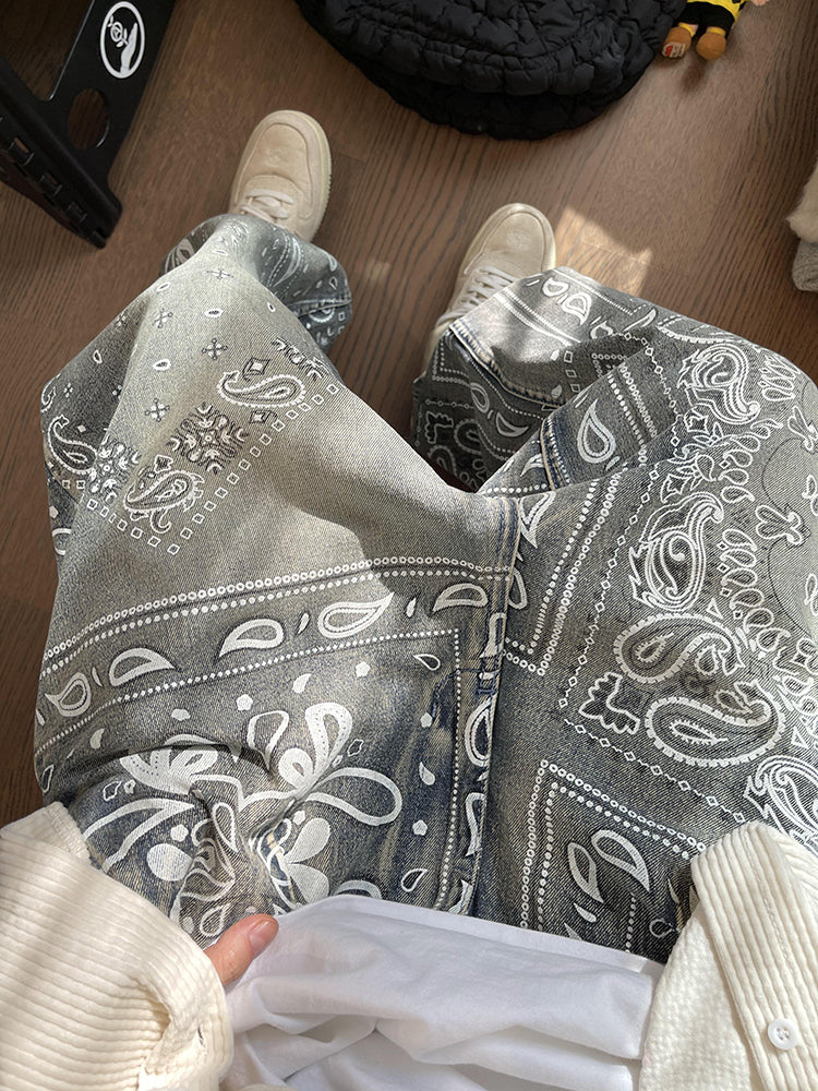FreyaVibe paisley print jeans close-up detail — all-over white bandana print texture on washed grey-blue denim fabric