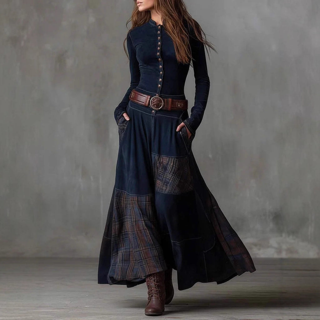 The Moorland Patchwork Maxi Dress FV in navy blue — button-front bodice with plaid panel wide-leg skirt, styled with leather belt and boots