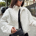 Polka dot cropped jacket in white and black – close-up front view showing collar and polka dot print detail
