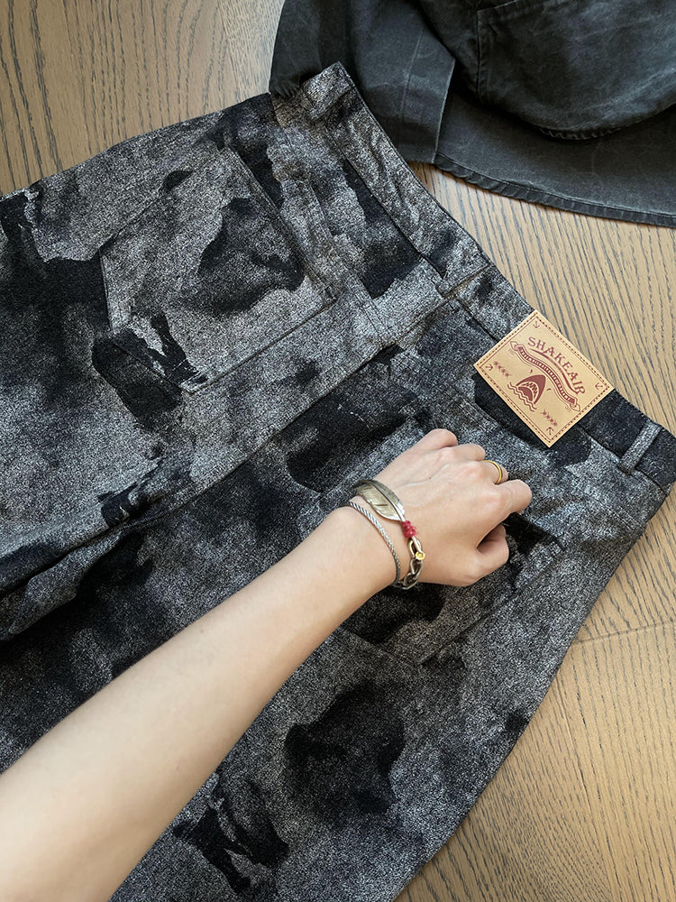 FreyaVibe tie-dye loose jeans waistband detail — close-up of leather label and grey black all-over print denim
