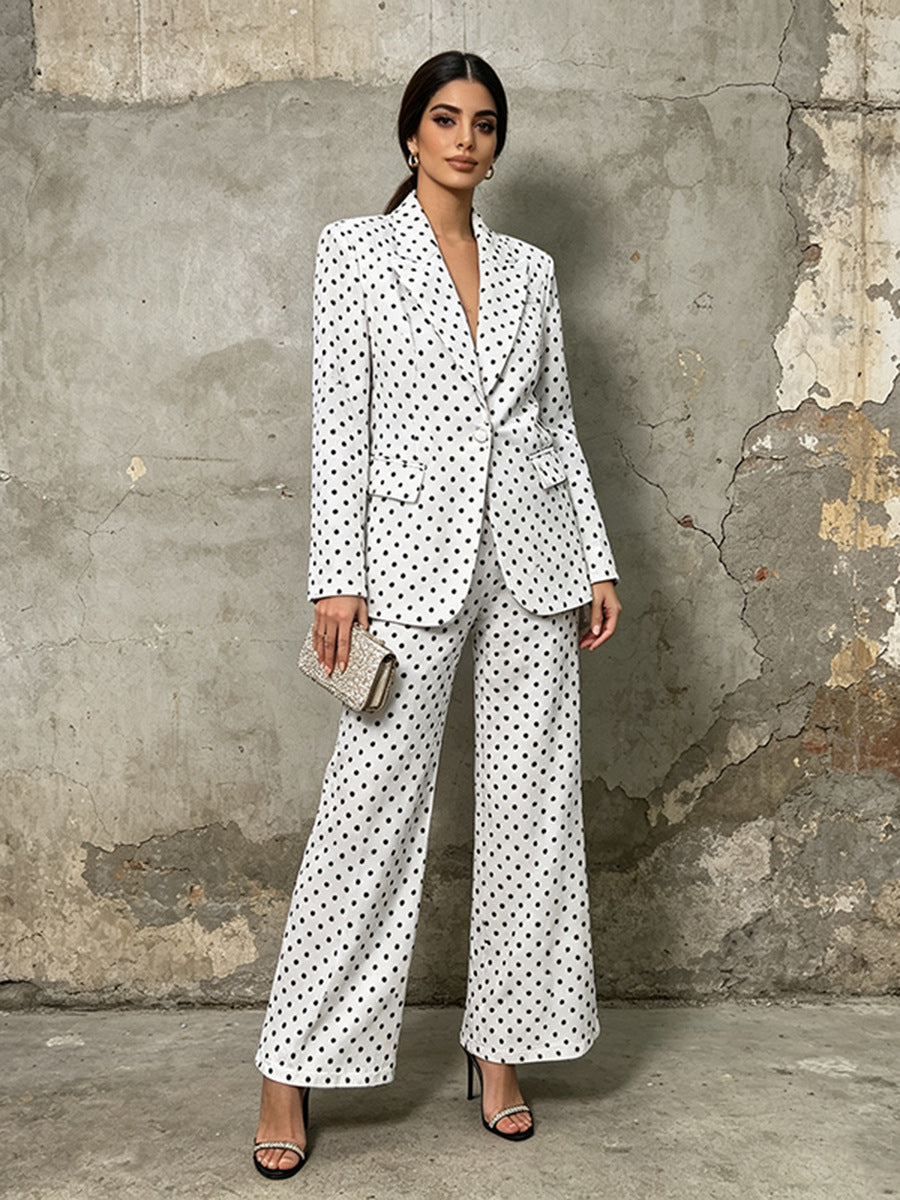 Polka dot blazer and wide leg trouser suit set in white – on model front view showing notched lapel and floor length trousers
