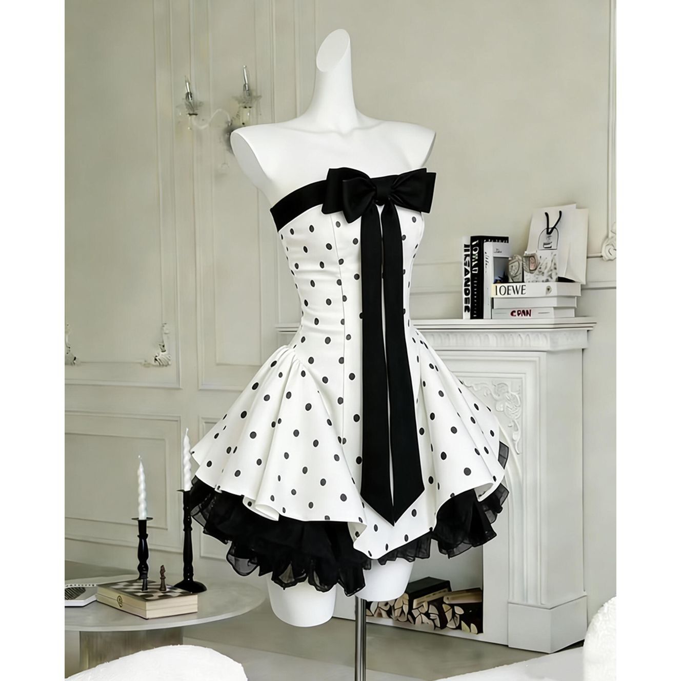 Polka dot strapless mini dress – front view showing full skirt silhouette and black velvet bow at chest
