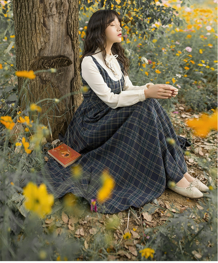 FreyaVibe Plaid Pinafore Swing Dress — seated countryside pose with open book, literary heritage aesthetic